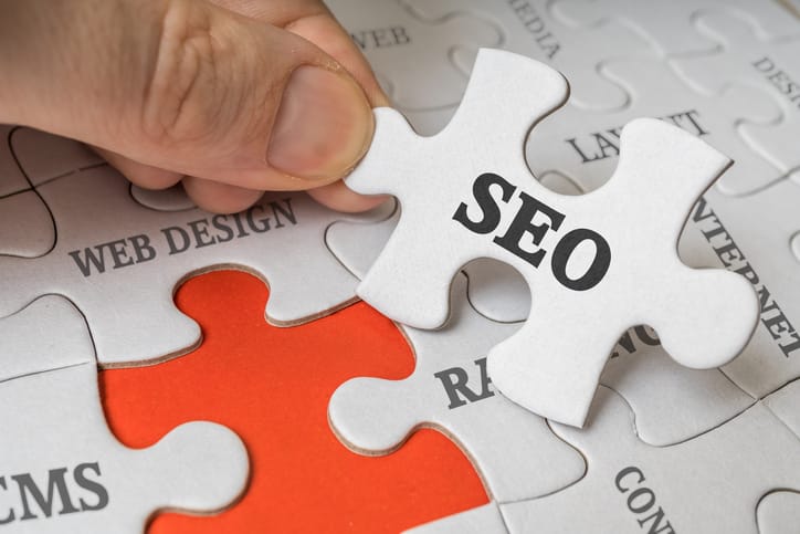 SEO (Search engine optimization) concept. Man is solving puzzle.